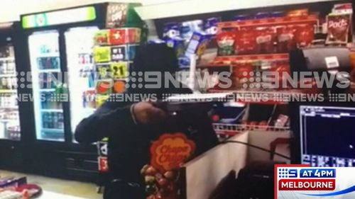 A man who was caught on CCTV camera pointing a shotgun in the face of a Melbourne shop employee has been arrested. Picture: 9NEWS.