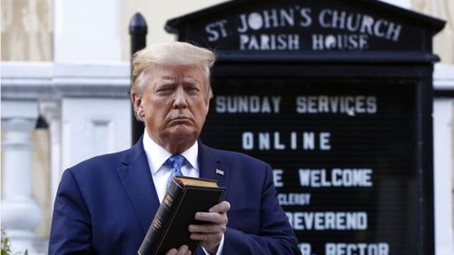 Donald Trump holds a Bible as he visits St John's Church across Lafayette Park from the White House. 