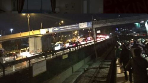 Passengers line the tracks after a blast on Istanbul's metro system.