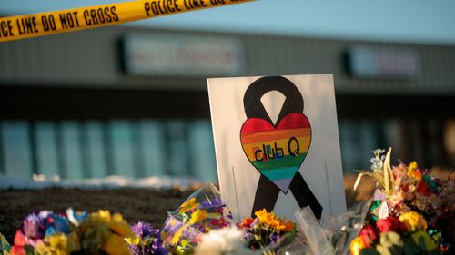 A sign at the growing memorial at the scene, related to the shooting inside Club Q