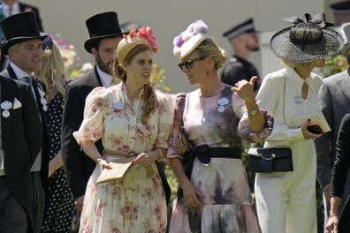 Princess Beatrice, center left, and Zara Tindall, center right, chat as they stand in the paddock on day one of the Royal Ascot horse racing meeting, at Ascot Racecourse, in Ascot, England, Tuesday June 14, 2022. 