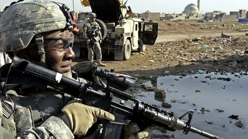 In this 2006 photo a US Army soldier from the 2nd Infantry Battalion, 17th Field Artillery Regiment looks on before the start of a mission to monitor a mosque during Friday prayers in Baghdad, Iraq.