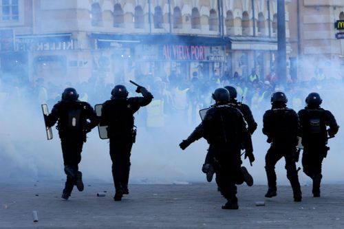 Thousands of protestors have taken over the streets of Paris, setting fire to cars, smashing shop windows, and attacking military police. 