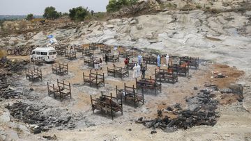 Bodies of people who died of COVID-19 are cremated at an open crematorium on the outskirts of Bengaluru, Karnataka state, India. 