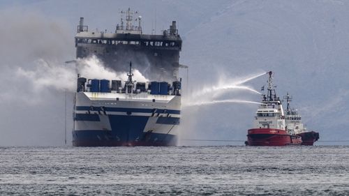 Smoke rises from the Italian-flagged Euroferry Olympia, which is on fire for third day, in the Ionian sea near the Greek island of Corfu, on Sunday, Feb. 20, 2022. Some 280 passengers and crew were rescued Friday well the number of people listed as missing was increased from 11 to 12 after authorities discovered that one person on the Italy-bound vessel was not on the passenger list and was believed to be a migrant. (AP Photo/Petros Giannakouris)
