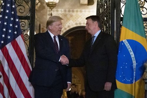 President Donald Trump shakes hands with Brazilian President Jair Bolsonaro at Mar-a-Lago.