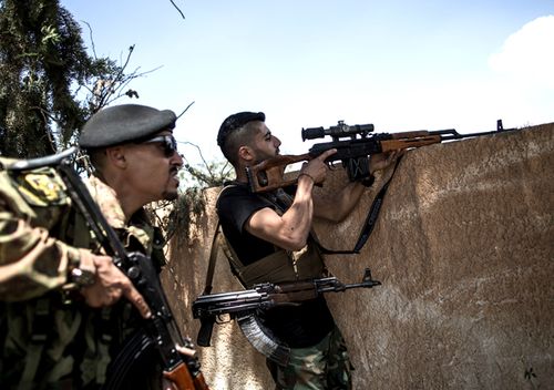 Fighters from forces of the UN-backed Libyan government fire at the Libyan National Army  troops at Al-Sawani front line near Tripoli airport in Tripoli, Libya, on May 15, 2019