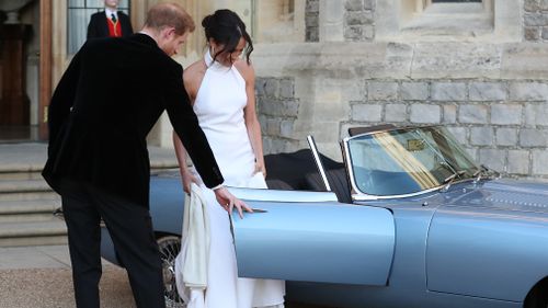 The first time the dress was revealed was as the newlyweds hopped into a vintage Jag to go to their evening reception at Frogmore House. Picture: Getty