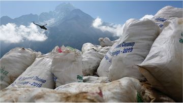 Local cleanup crews are struggling to remove the excess garbage brought to Mount Everest by foreign climbers.