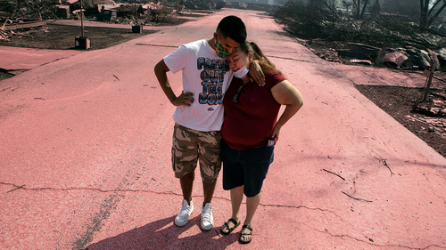 Maria Centeno from Mexico, is consoled by her son, Hector Rocha after seeing their destroyed mobile home at the Talent Mobile Estates as wild fires devastate the region on Thursday in Talent, Ore.  (AP Photo/Paula Bronstein)