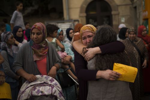 Members of the local Muslim community gather along with relatives of young men believed responsible for the attacks in Barcelona and Cambrils. (AP)