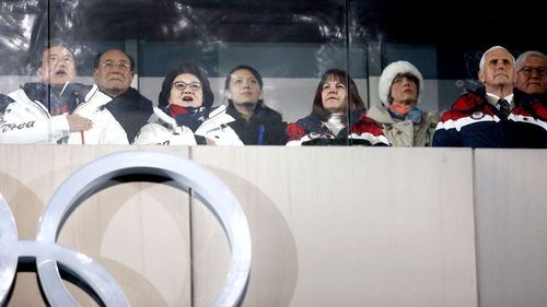 Kim Yong Nam, the 90-year-old president of the Presidium of the North's Parliament, third from left in the back and Kim Jong Un's sister Kim Yo Jong, centre, observe with South Korean President Moon Jae-in, front left, first lady Kim Jung-sook and second lady Karen Pence, and United States Vice President Mike Pence during the opening ceremony of the 2018 Winter Olympics in Pyeongchang, South Korea. (AAP)
