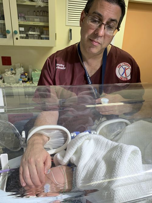 Doctor Timothy Hardcastle treats a baby in hospital after she was rescued from a storm water pipe in Durban, South Africa.