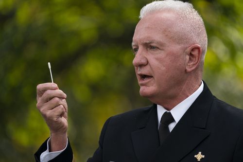 Admiral Brett Giroir, Assistant Secretary for Health, Department of Health and Human Services, shows a nasal swab during a coronavirus testing event with President Donald Trump, in the Rose Garden of the White House, Monday, Sept. 28, 2020, in Washington. (AP Photo/Evan Vucci)