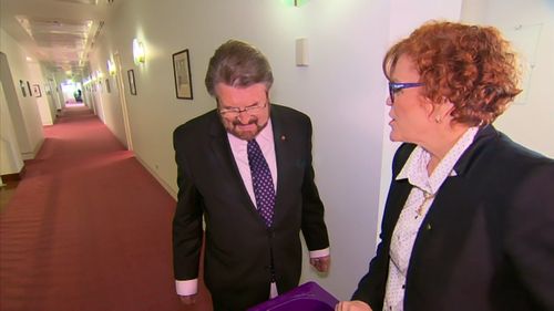 Ms O'Toole shows Senator Derryn Hinch her haul of book. Picture: 9NEWS