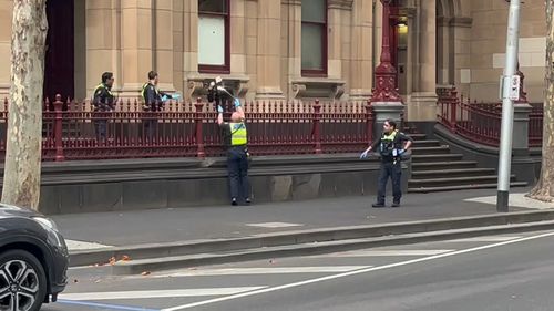 A man and a woman have been arrested for allegedly assaulting protective services officers at a court in Melbourne. 