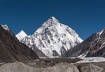 How high is Karakoram's tallest peak, K2, on the China-Pakistan border?