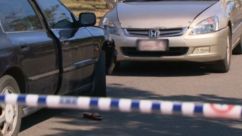 The woman's car was allegedly rammed before she was chased with a machete. (9NEWS)