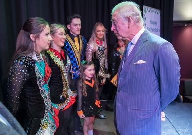 The Prince of Wales talks to Irish dancers during a visit with Camilla, Duchess of Cornwall to the Irish Cultural Centre to celebrate the Centre's 25th anniversary in the run-up to St Patrick's Day