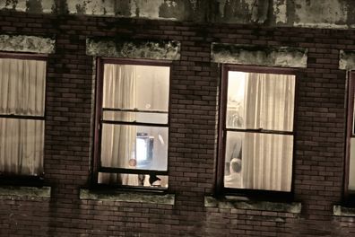 Neighbour sees couple having sex through curtains.
