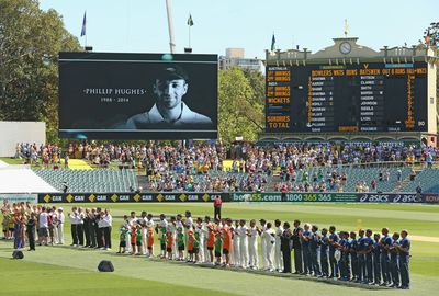 Players stand in the middle during 63 seconds of applause for Hughes.