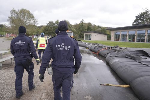 Employees from The Danish Emergency Management Agency prepare for the storm to come at Sonderballe Strand near Haderslev southern, Denmark Thursday, Oct. 19, 2023.