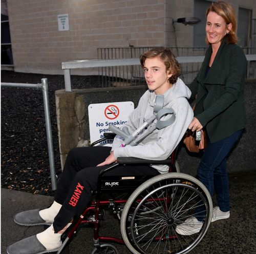 Sam Kanizay on a wheelchair pushed by his mother Jane, from the Dandenong Hospital. (AAP)