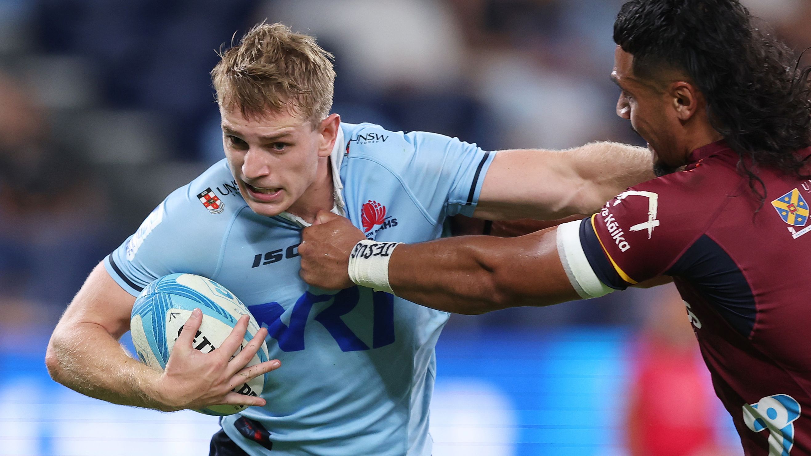 Max Jorgensen of the Waratahs is tackled by Tanielu Telea of the Highlanders during the round three Super Rugby Pacific match.