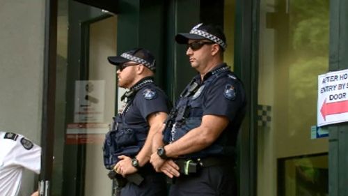 Police outside the QPS headquarters on Roma St. (9NEWS)