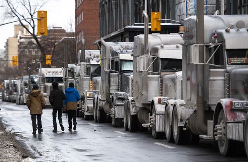 Trucks are parked on Metcalfe Street as a rally against COVID-19 restrictions, which began as a cross-country convoy protesting a federal vaccine mandate for truckers, continues in Ottawa, Ontario, on Sunday, Jan. 30, 2022.