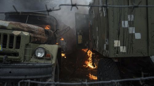 Ukrainian military track burns at an air defence base in the aftermath of an apparent Russian strike in Mariupol, Ukraine.