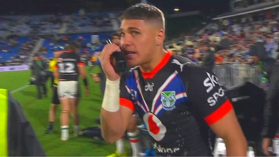 Warriors young gun Reece Walsh speaks to his coach over a walkie talkie.