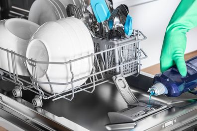 Housewife add rinse aid to dishwasher for clean and shine dishes