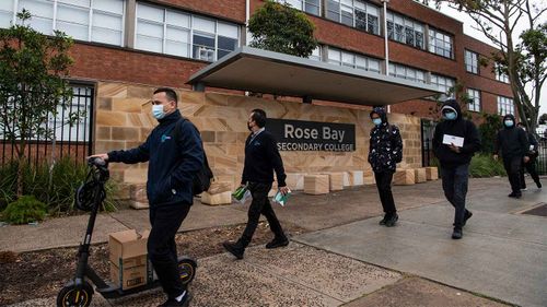 Cleaners arrive at Rose Bay Secondary College, following a student testing positive to COVID-19.