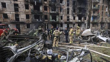 Emergency workers inspect a damaged multi-storey apartment building caused by the latest rocket Russian attack in Kryvyi Rih, Ukraine, Tuesday, June 13, 2023.  