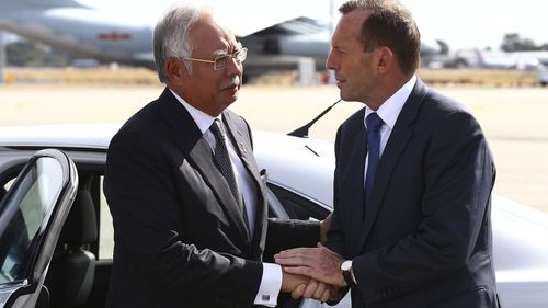  In this April 3, 2014, file photo, Australian then Prime Minister Tony Abbott, right, shakes hands with Malaysian then Prime Minister Najib Razak as Razak prepares to depart Australia after his visit during the search of the missing Malaysia Airlines flight MH370 at Perth International Airport, Australia. Abbott has claimed the "top levels" of the Malaysian government long suspected the vanishing of a plane almost six years ago was a mass murder-suicide by the pilot. 