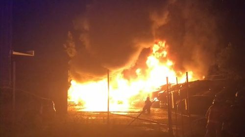 Huge flames broke out in the wrecking yard, but no neighbouring businesses were damaged.