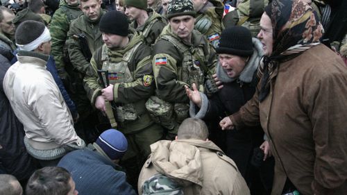Donetsk locals react after separatists handed over Ukrainian prisoners in January. (AAP) 