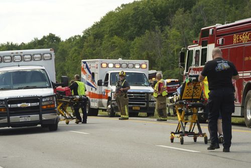 Rescue personnel work the scene of a tour bus that crashed and rolled over on the New York State Thruway near Pembroke, N.Y., Friday, Aug. 22, 2025. (Libby March/The Buffalo News via AP)