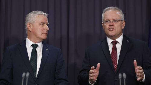 Prime Minister Scott Morrison and Deputy Prime Minister Michael McCormack speak to the media about a ministerial reshuffle at Parliament House in Canberra.