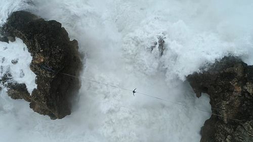 Brazilian Emerson Machado has been filmed attempting to walk on a slackline between rock faces in Portugal (Supplied).