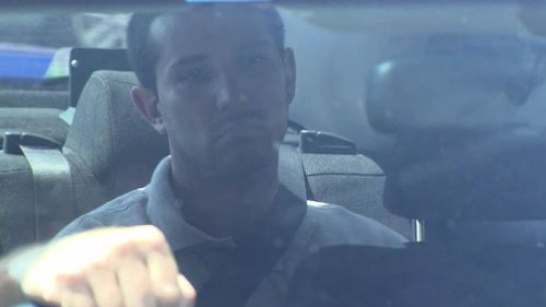 Mark Dayney in a police vehicle ahead of his first court appearance.