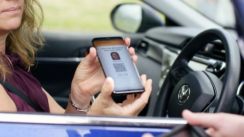 A driver presenting their digital licence app to a Queensland police officer.