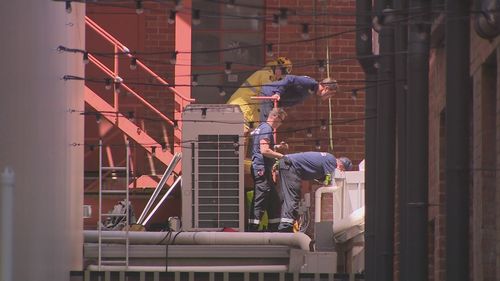 A man in his 20s has been rescued after hours stuck between two buildings in Perth's main shopping streets.