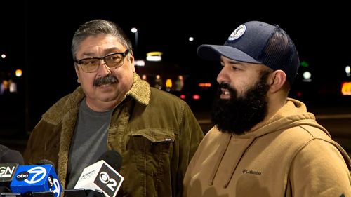Mario Garcia, left, and his son-in-law Nivardo Delatorre found the man trapped in the mangled pickup truck.