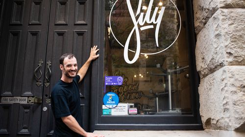 Nick White with his new purple flag sticker at SILY on Kent St in the Sydney CBD.