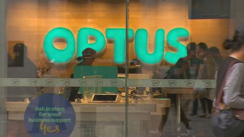 Customers inside an Optus store.