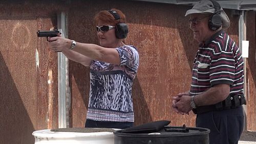 The One Nation Senator vowed to obtain a gun license after firing a glock and a ‘Dirty Harry’-style gun. (Facebook / Pauline Hanson's Please Explain)