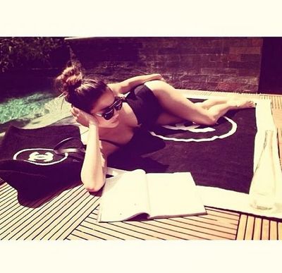 She might be in LA, but she's still enjoying the poolside sun. All a girl needs to do that is Chanel, right?