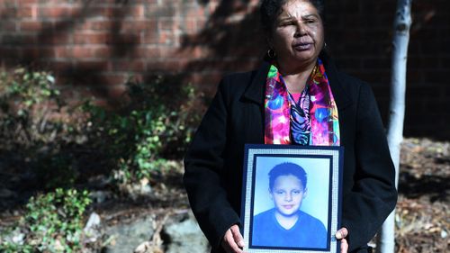 Julie Szabo, the mother of Arthur Haines, who died in a house fire in 1998, holds a picture of her son.